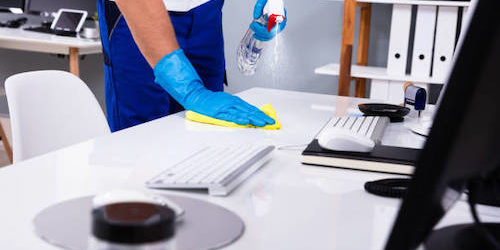 A Commercial Janitorial crew member cleaning a commercial restroom inside a commercial office building / facility in Mountain View, California 