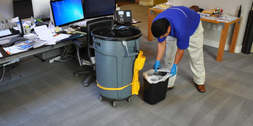 Commercial Janitorial service worker vacuuming a commercial carpet near San Jose, California